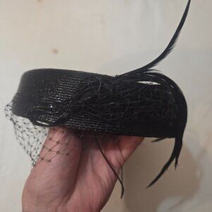 Paula Del Percio small black hat with feather and netting.